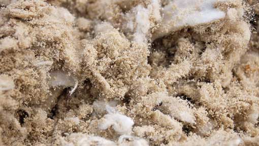 Textiles and fibers mixed with sand