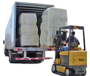 offloading bales of footing with forklift