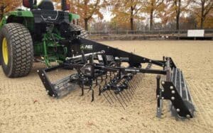 Tractor for grooming horse footing product