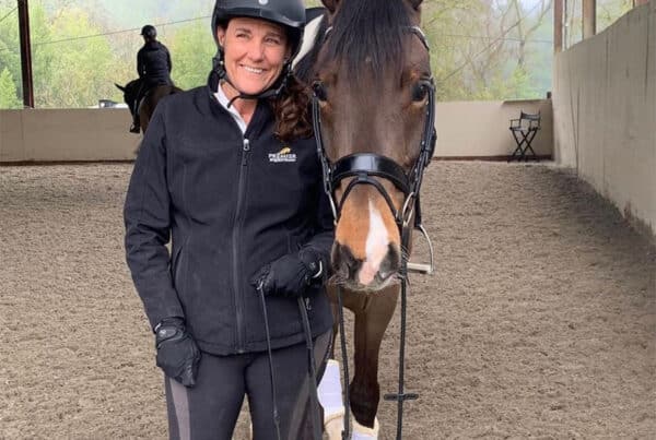 Rider with her horse in a riding arena