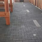 Black rubber pavers placed in tack area