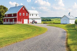 gravel road with a barn